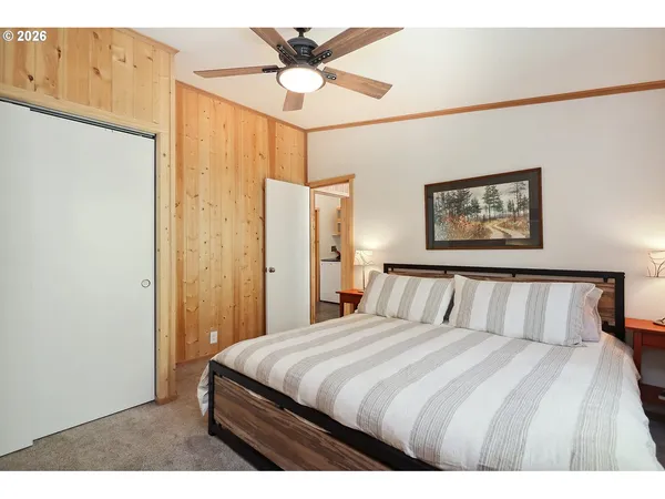 a bedroom with a large bed and a chandelier
