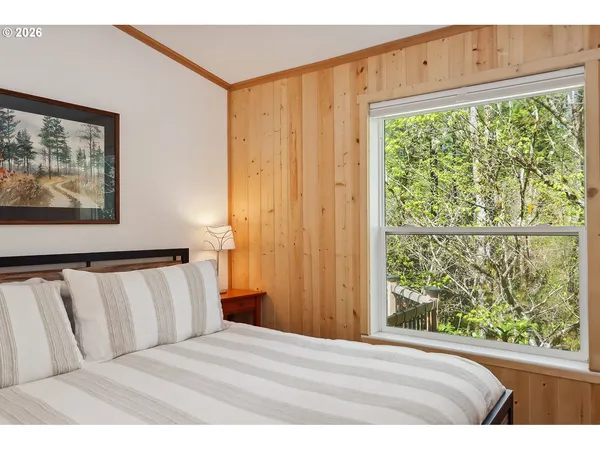 a bedroom with a bed and a painting on the wall
