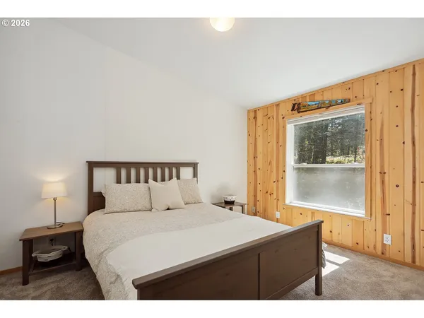 a bedroom with a bed and a night stand