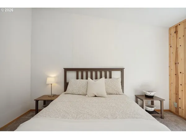 a bedroom with a bed and a night stand