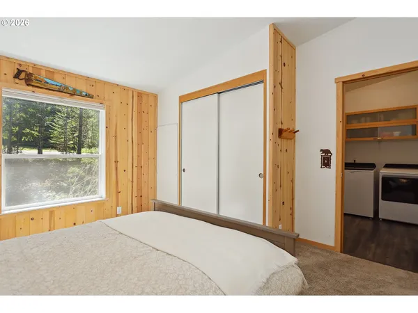 a bedroom with a bed and a large window