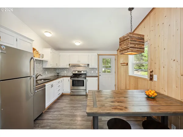 a kitchen with kitchen island a sink stainless steel appliances and cabinets