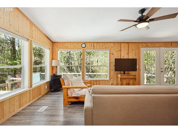 a living room with furniture tv and a large window