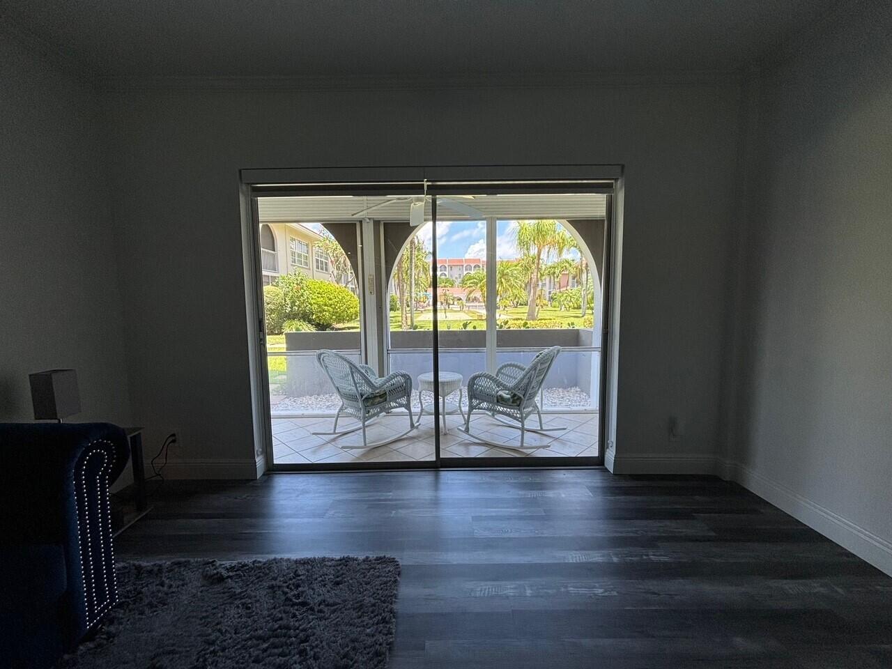 250 Northeast 20th Street, Unit 124S Boca Raton, FL 33431 - Photo 13 of 14 an empty room with wooden floor and furniture