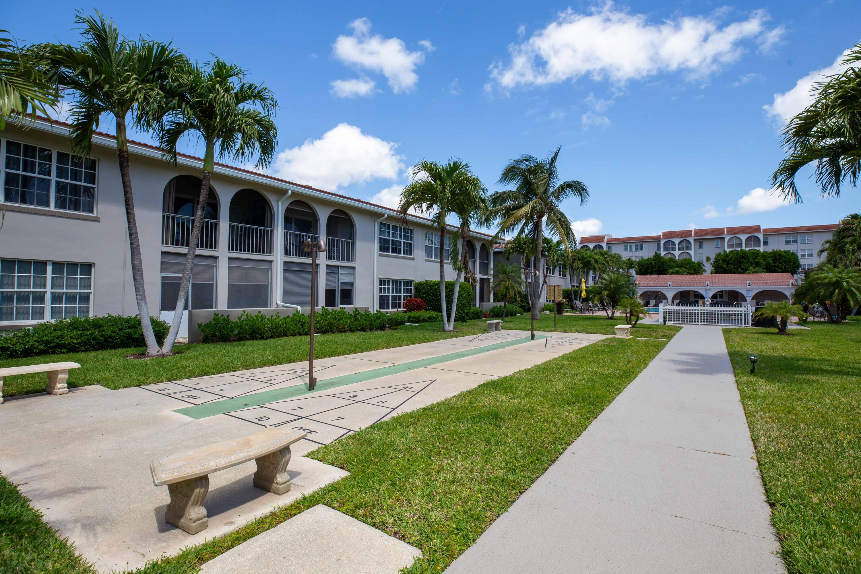 250 Northeast 20th Street, Unit 124S Boca Raton, FL 33431 - Photo 2 of 14 a view of a house with a yard