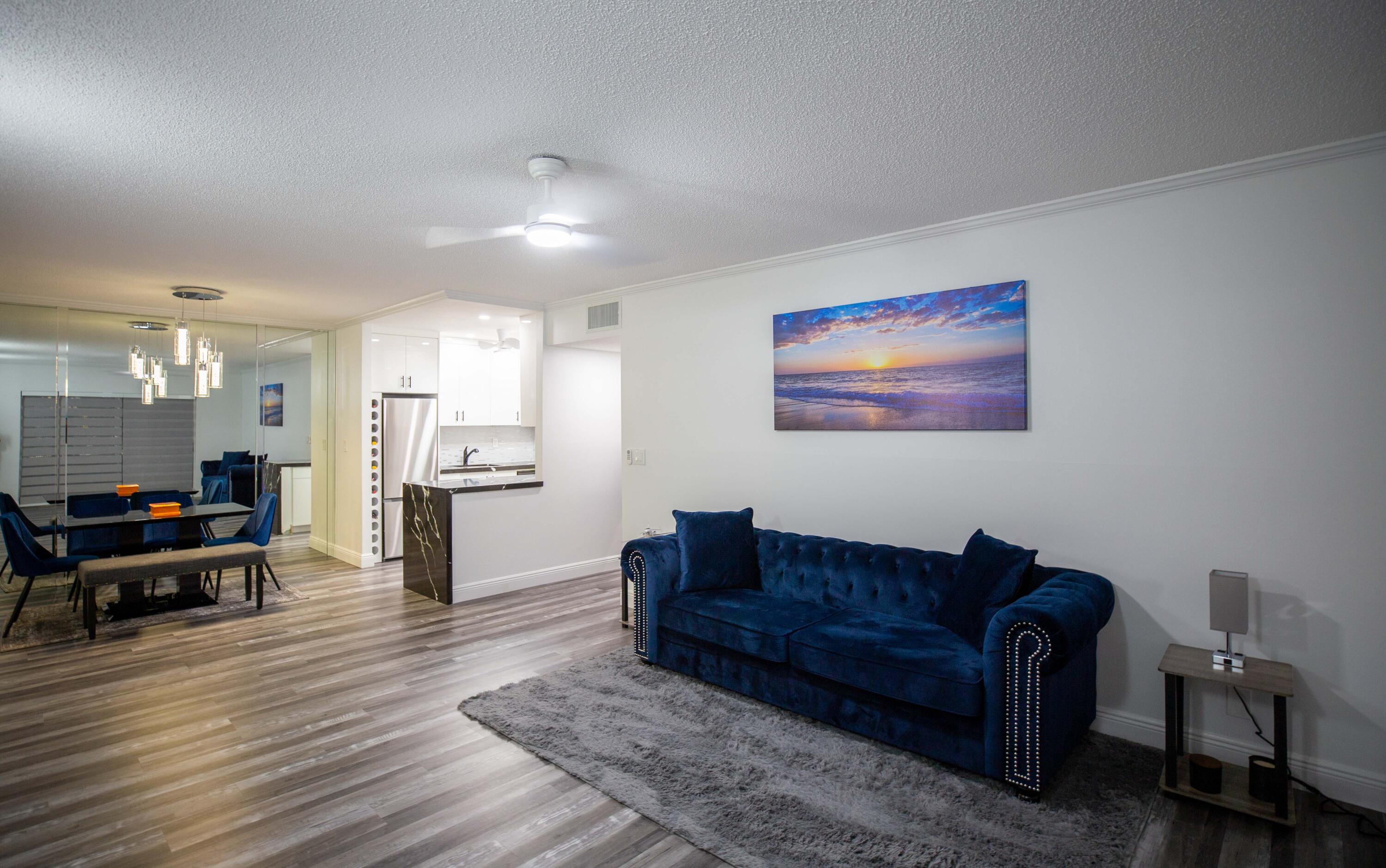 250 Northeast 20th Street, Unit 124S Boca Raton, FL 33431 - Photo 7 of 14 a living room with furniture and a view of kitchen