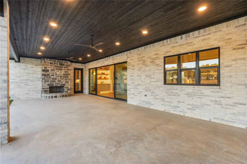 724 Cooper Trail Weatherford, TX 76087 - Photo 38 of 40 View of patio / terrace with ceiling fan and an outdoor stone fireplace