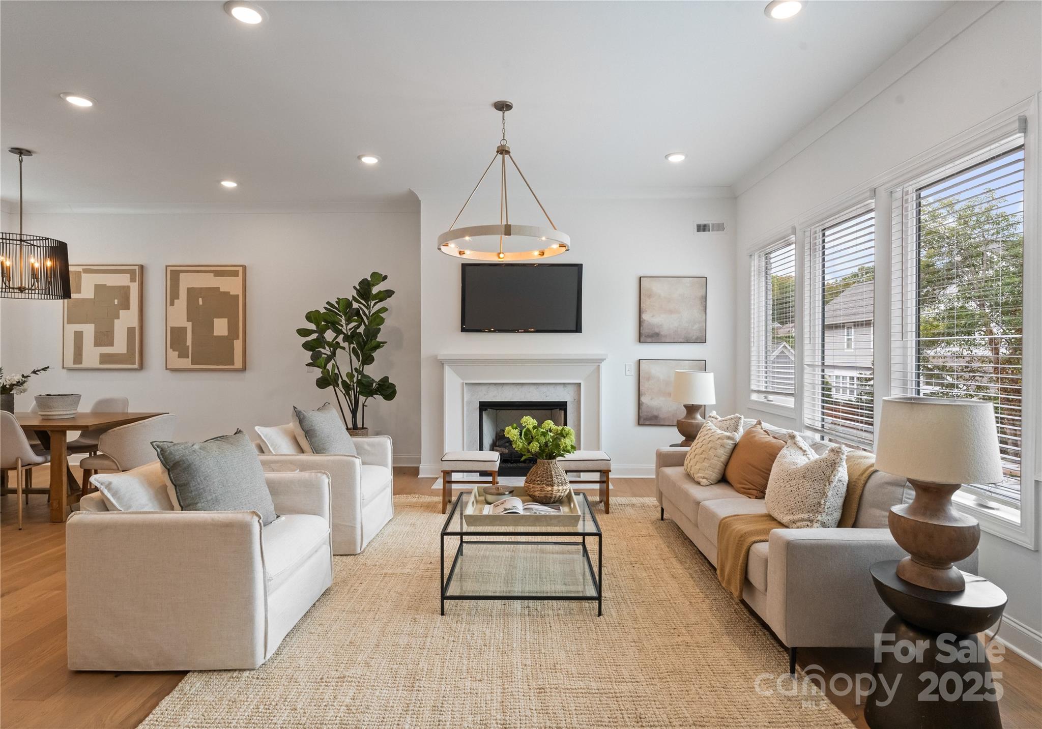 4215 Walker Road Charlotte, NC 28211 - Photo 3 of 43 a living room with furniture a fireplace and a chandelier