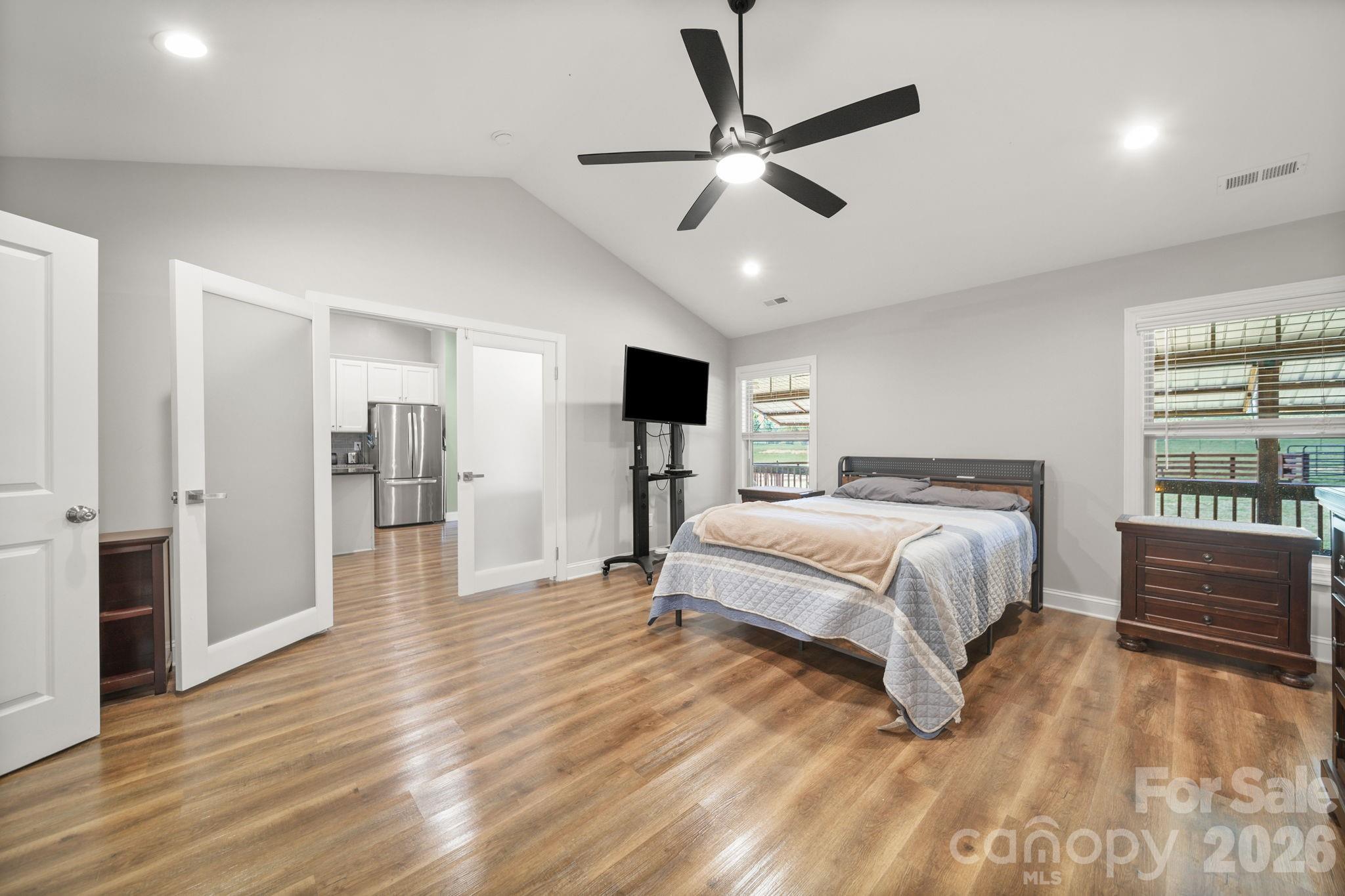 5311 Flint Ridge Marshville, NC 28103 - Photo 15 of 38 a bedroom with a large bed and a flat screen tv