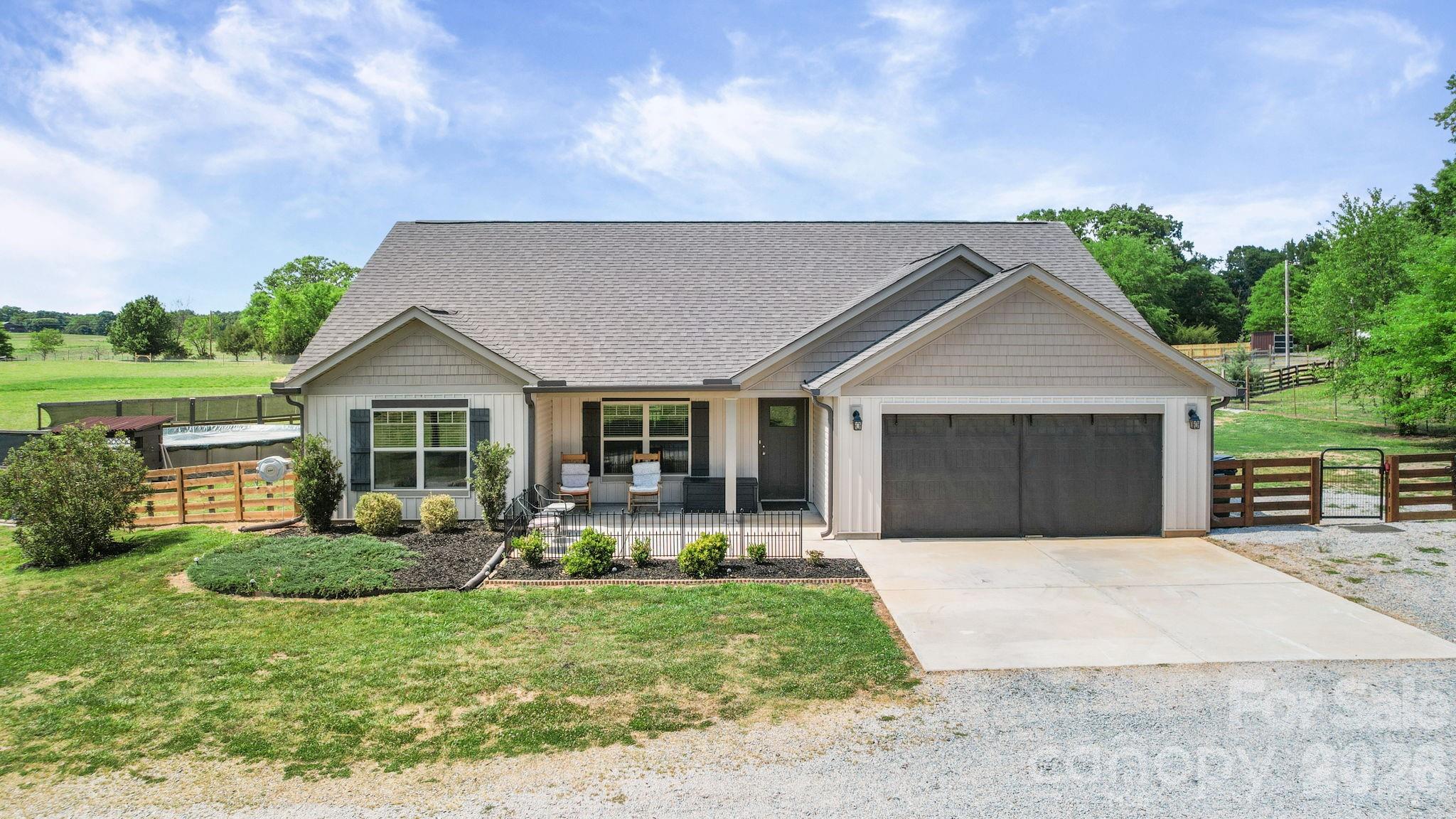 5311 Flint Ridge Marshville, NC 28103 - Photo 2 of 38 a front view of a house with a yard and garage