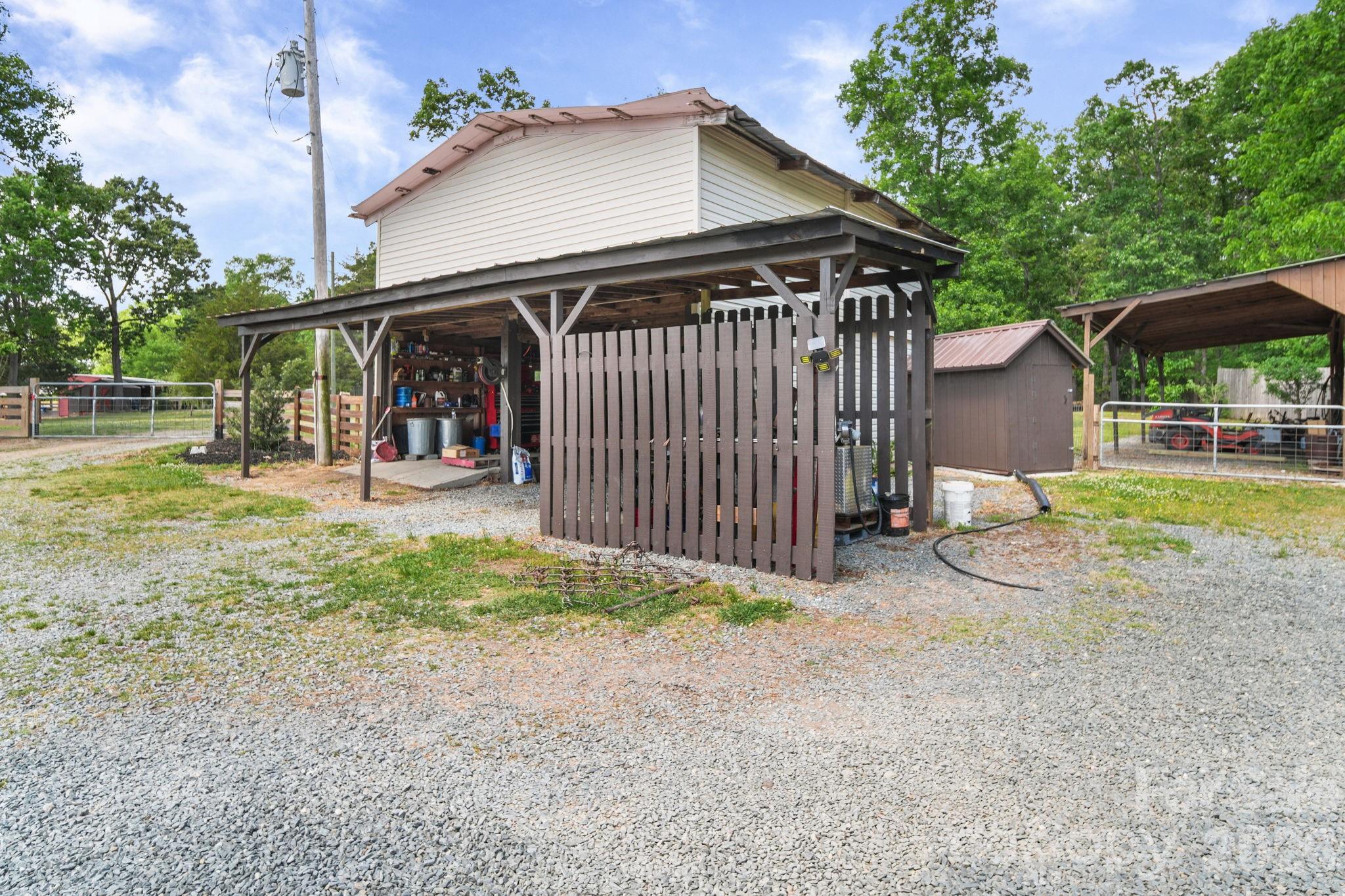 5311 Flint Ridge Marshville, NC 28103 - Photo 31 of 38 a view of a house with a yard and lawn chairs