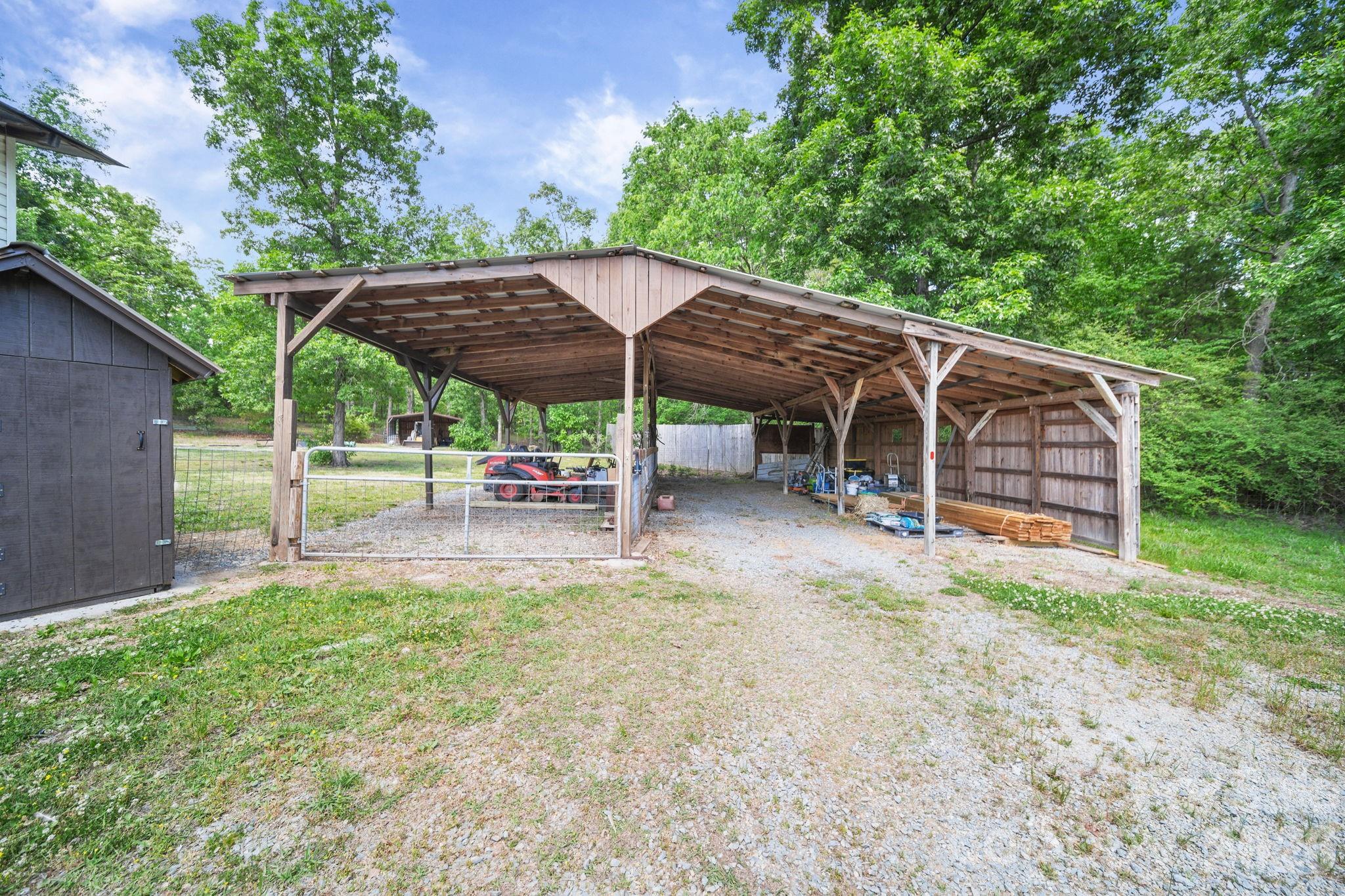 5311 Flint Ridge Marshville, NC 28103 - Photo 33 of 38 a view of a patio with table and chairs under an umbrella
