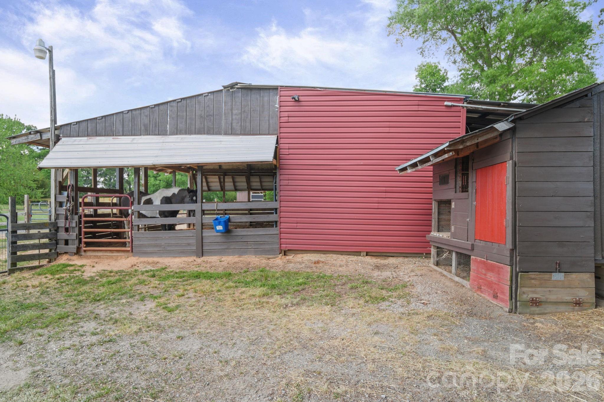 5311 Flint Ridge Marshville, NC 28103 - Photo 35 of 38 a backyard of a house with barbeque oven table and chairs