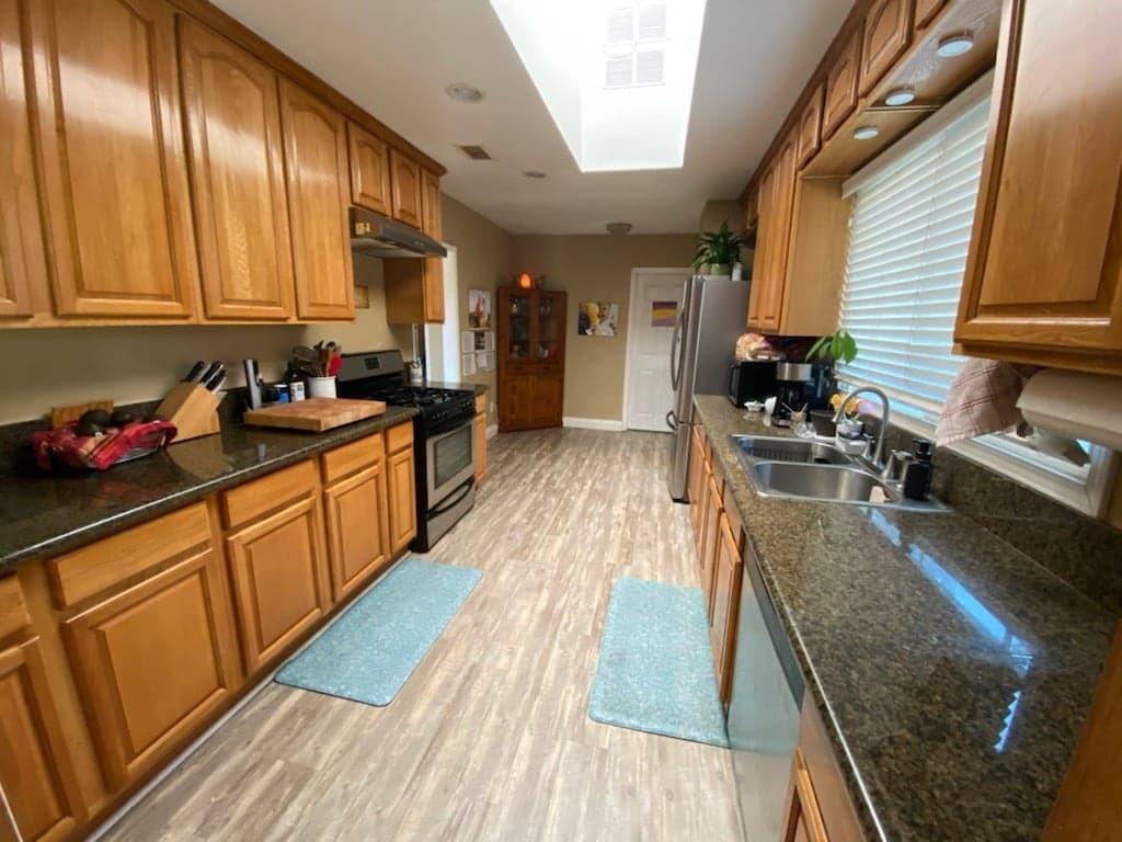 9035 Rosedale Drive Spring Valley, CA 91977 - Photo 6 of 14 a kitchen with stainless steel appliances granite countertop wooden cabinets a stove top oven a sink and dishwasher