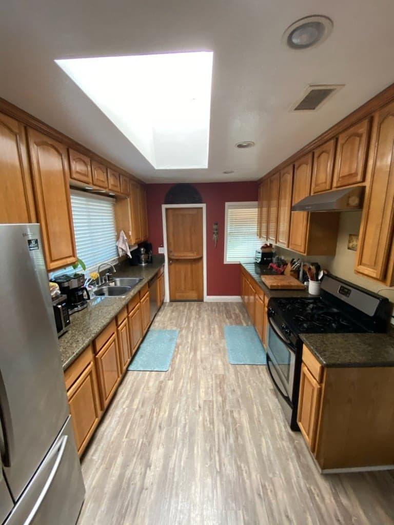 9035 Rosedale Drive Spring Valley, CA 91977 - Photo 8 of 14 a kitchen with stainless steel appliances a stove top oven a sink and a refrigerator