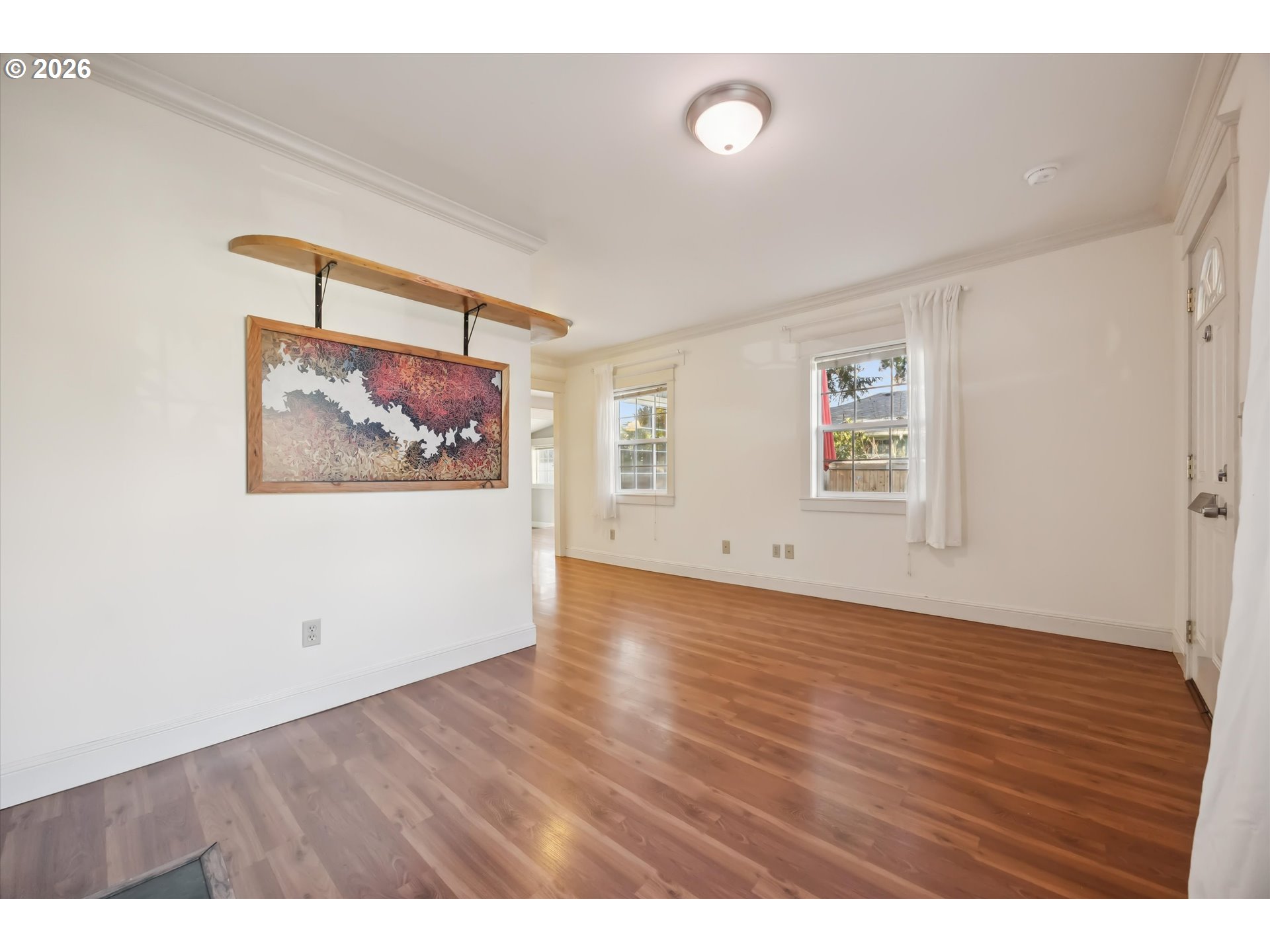 6118 Northeast Alton Street Portland, OR 97213 - Photo 12 of 46 a view of an empty room with wooden floor and a window
