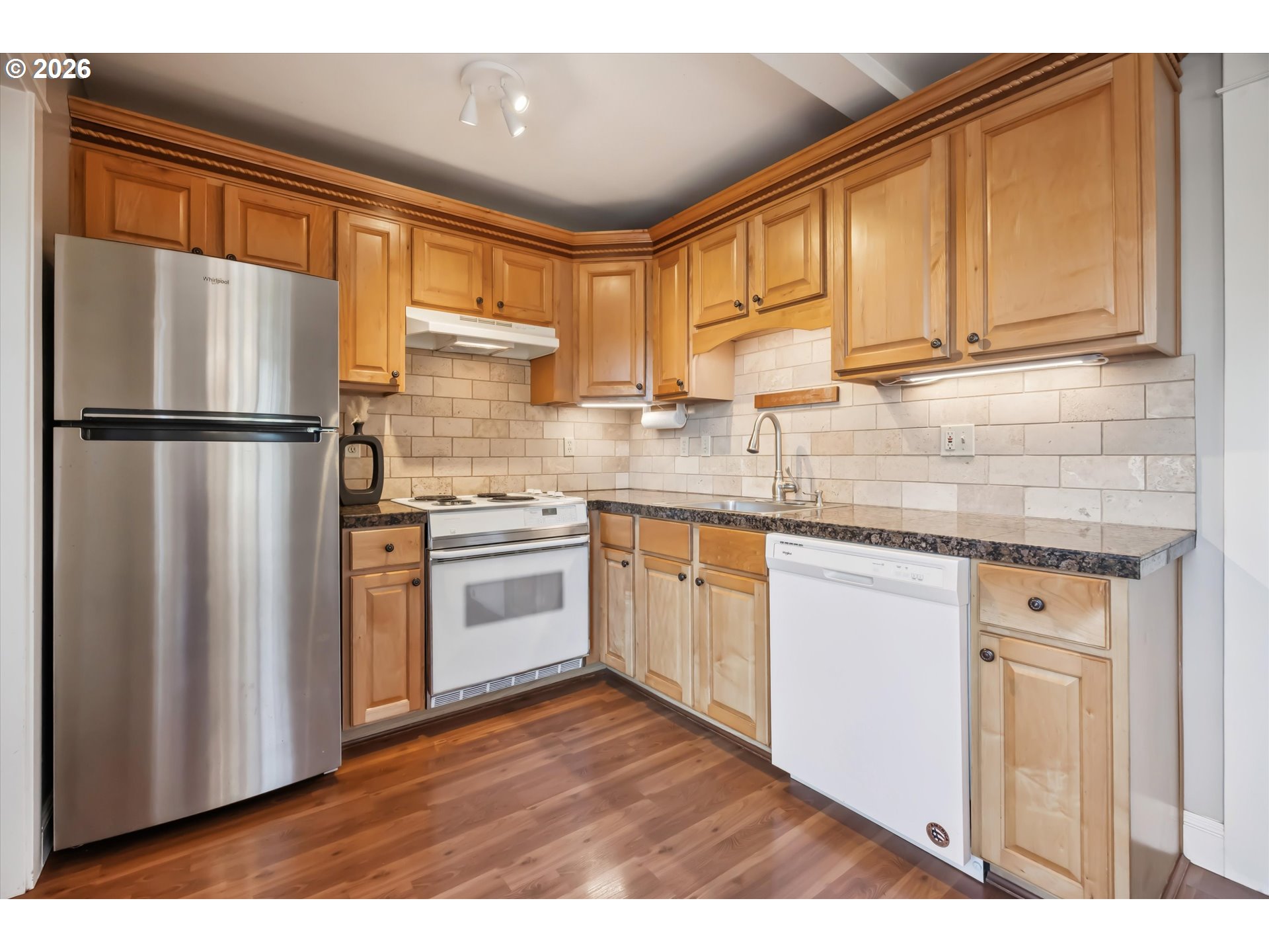 6118 Northeast Alton Street Portland, OR 97213 - Photo 15 of 46 a kitchen with stainless steel appliances granite countertop a refrigerator sink and cabinets