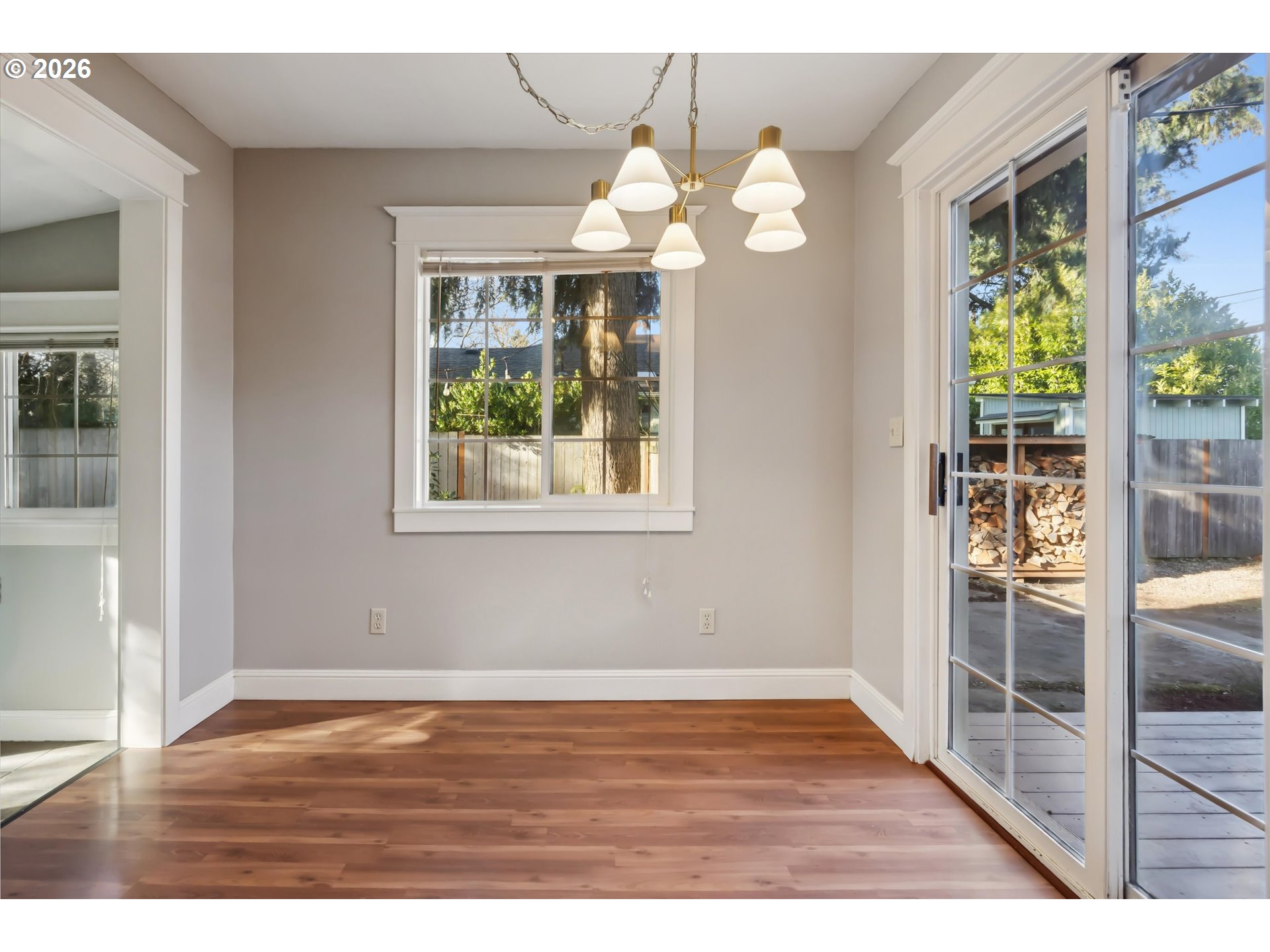 6118 Northeast Alton Street Portland, OR 97213 - Photo 19 of 46 a view of an empty room with wooden floor and a window