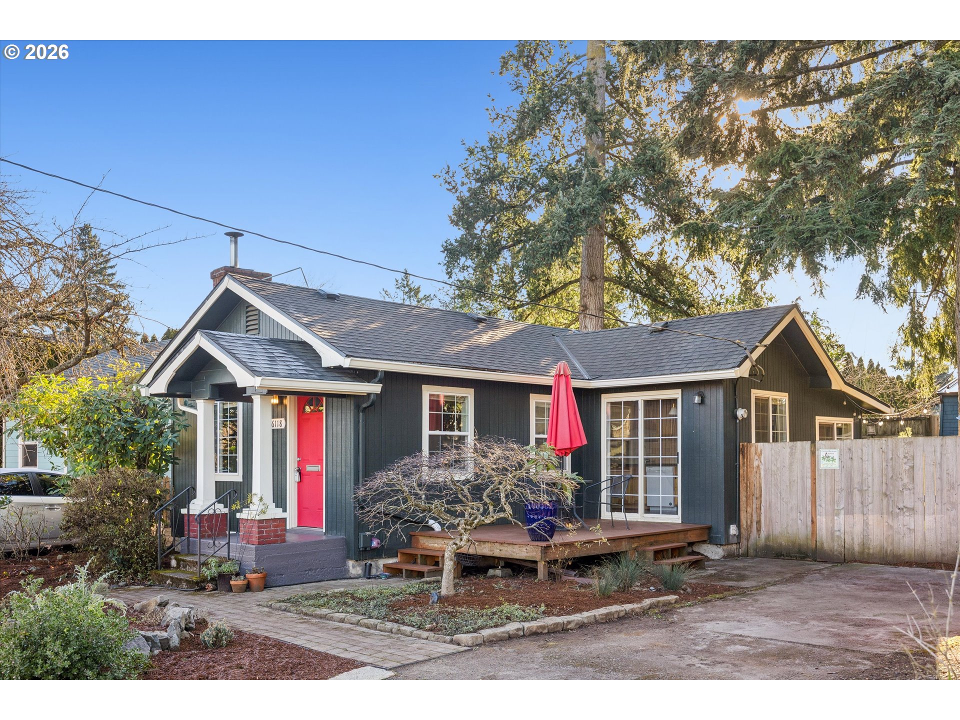 6118 Northeast Alton Street Portland, OR 97213 - Photo 4 of 46 a front view of a house with a yard and potted plants