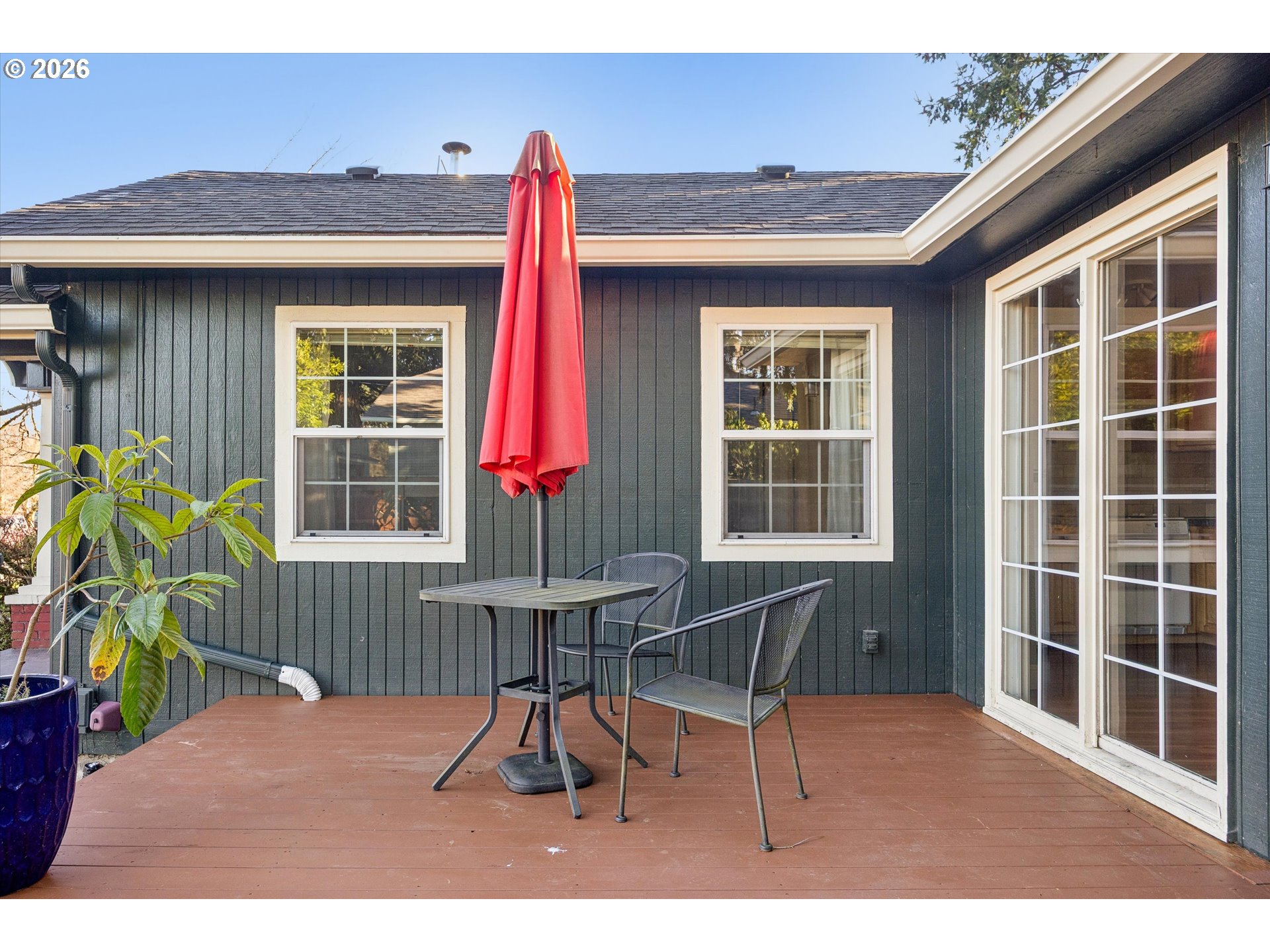 6118 Northeast Alton Street Portland, OR 97213 - Photo 6 of 46 a chair and table in front of a house