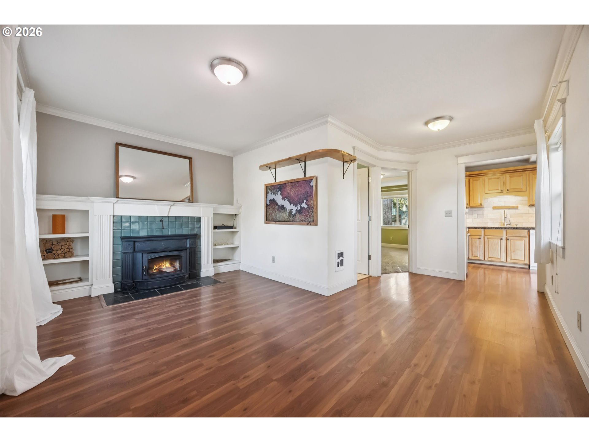 6118 Northeast Alton Street Portland, OR 97213 - Photo 7 of 46 a view of a room with wooden floor and fireplace