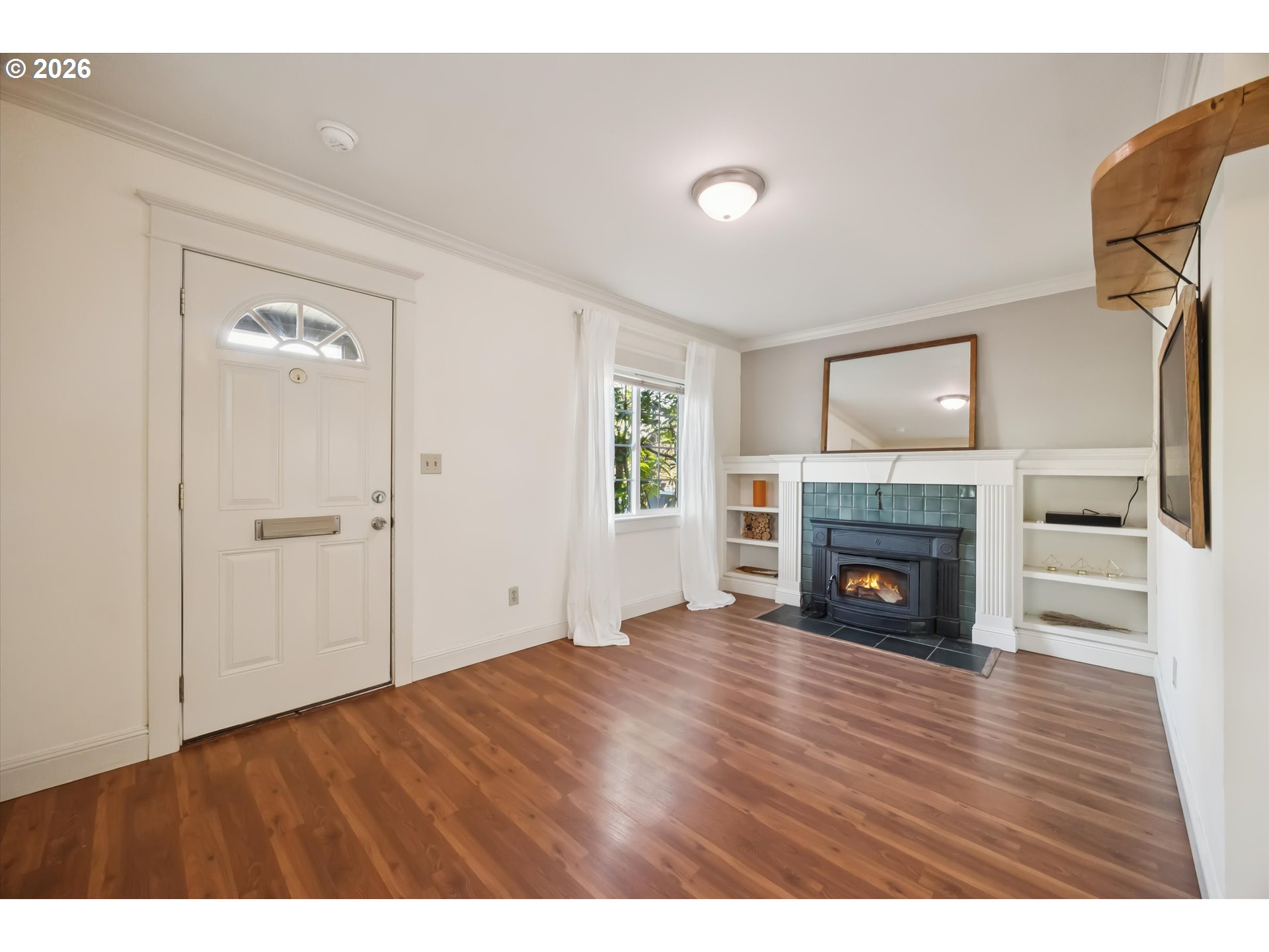 6118 Northeast Alton Street Portland, OR 97213 - Photo 8 of 46 a view of empty room with wooden floor and fireplace
