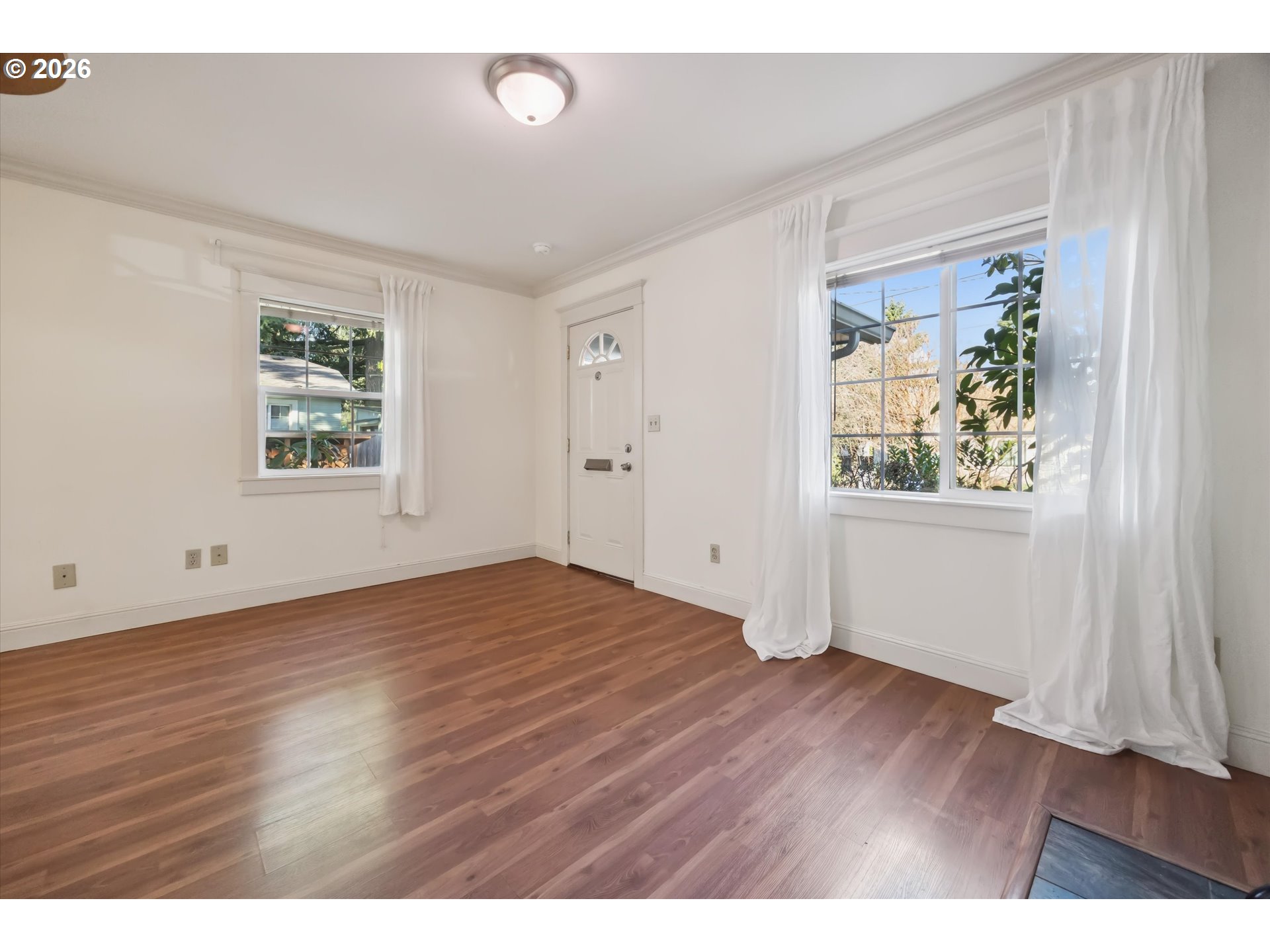 6118 Northeast Alton Street Portland, OR 97213 - Photo 10 of 46 an empty room with wooden floor and windows