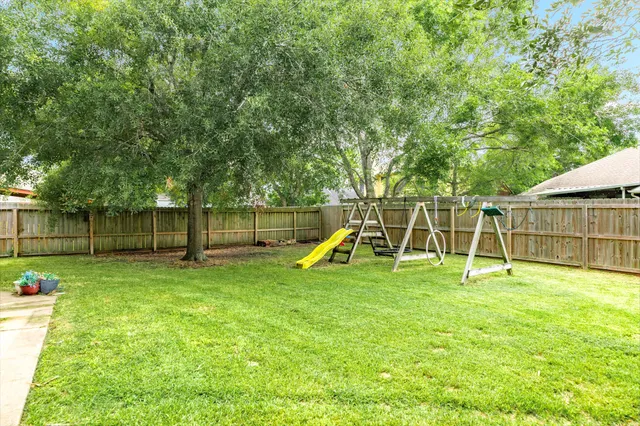 a view of a backyard with a slide and a slide
