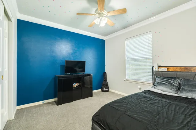 a bedroom with a bed and a television