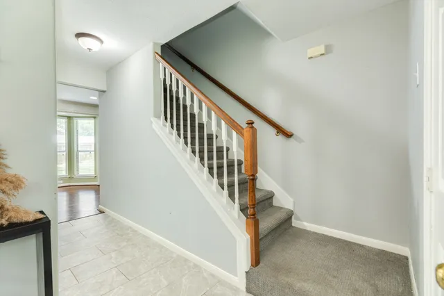 a view of staircase with white walls and windows