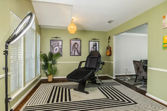 a view of a workspace with furniture and a window