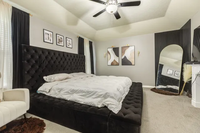 a bedroom with a bed and a chandelier