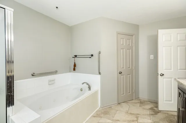 a bathroom with a bathtub and a shower