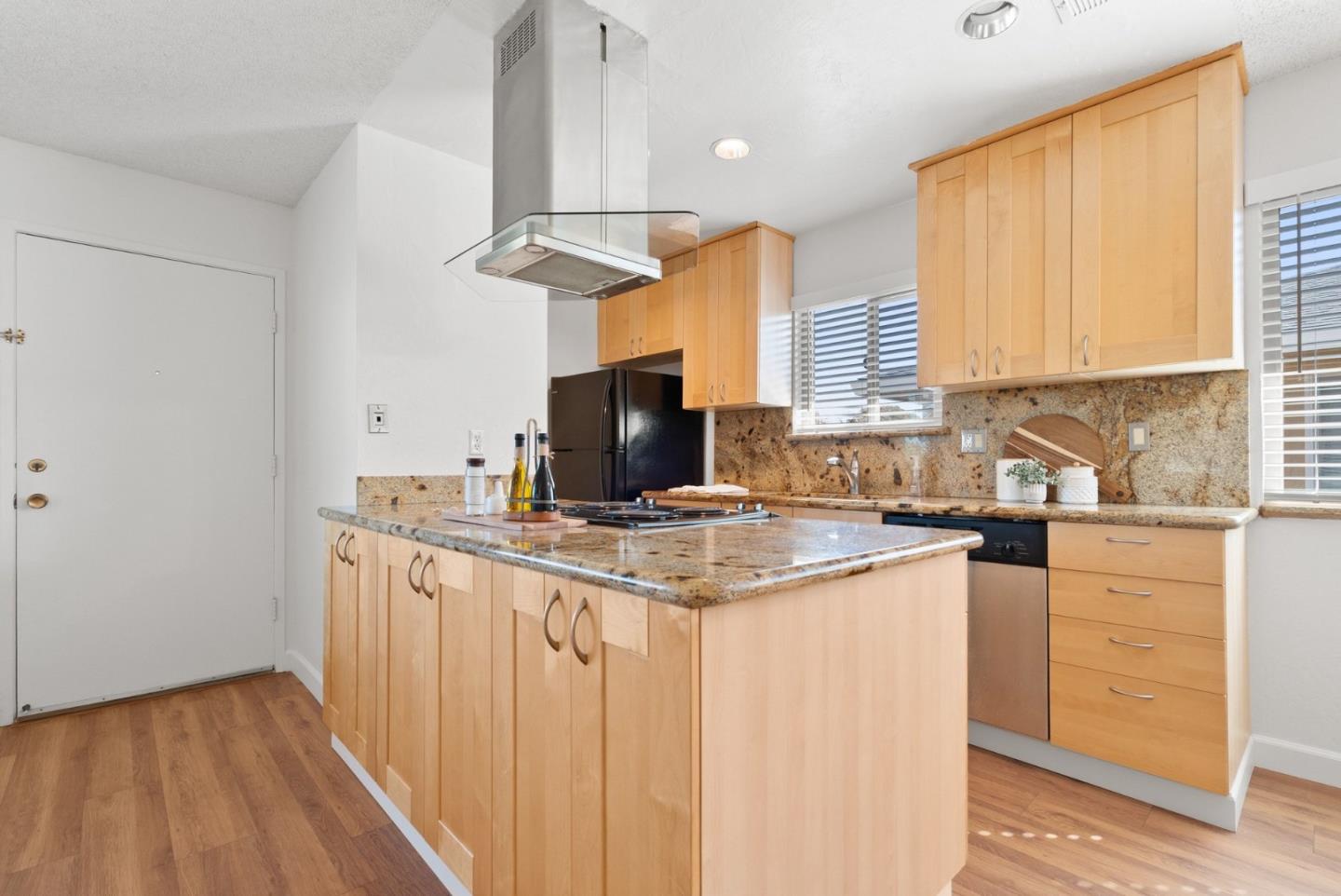 4465 Diamond Street, Unit 4 Capitola, CA 95010 - Photo 14 of 41 a kitchen with stainless steel appliances granite countertop a sink a stove and a refrigerator
