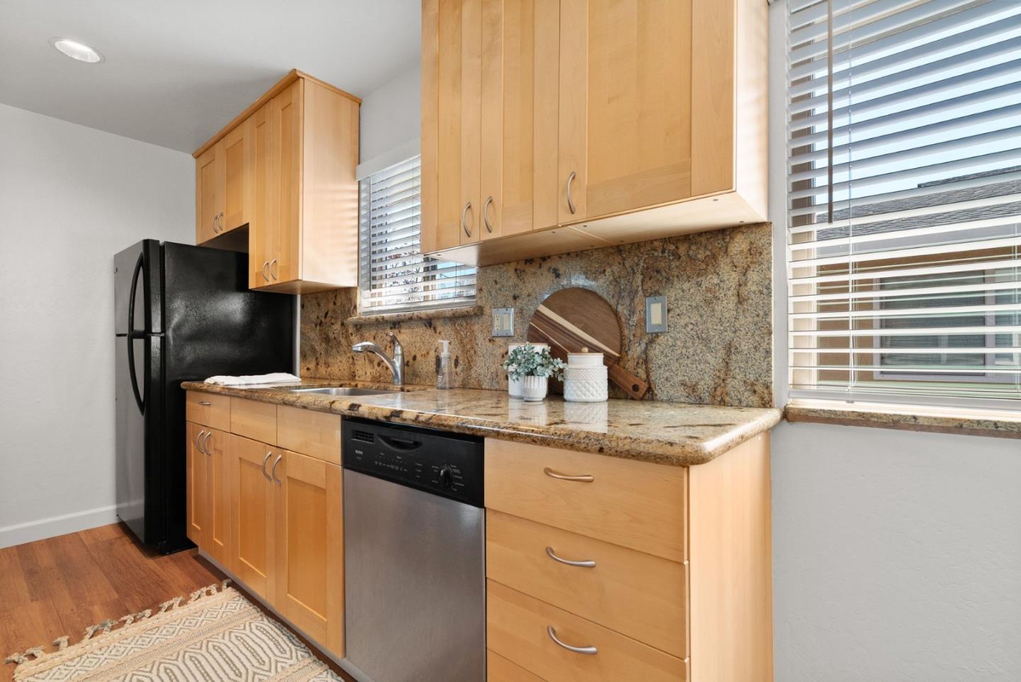 4465 Diamond Street, Unit 4 Capitola, CA 95010 - Photo 17 of 41 a kitchen with stainless steel appliances granite countertop a sink stove and refrigerator