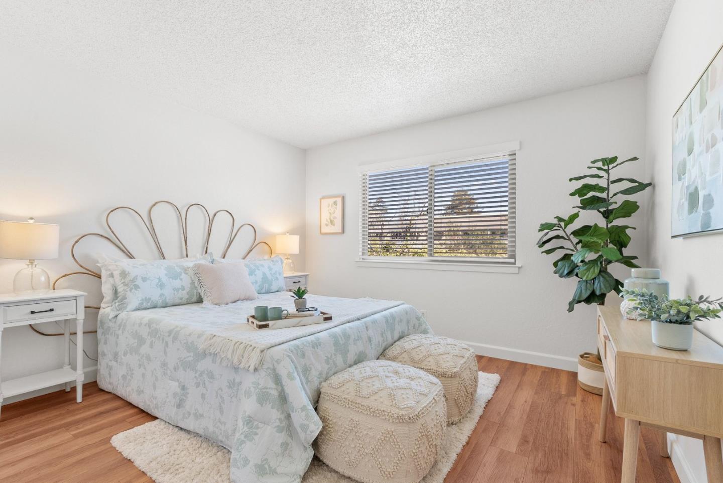4465 Diamond Street, Unit 4 Capitola, CA 95010 - Photo 22 of 41 a bedroom with a large bed and a potted plant