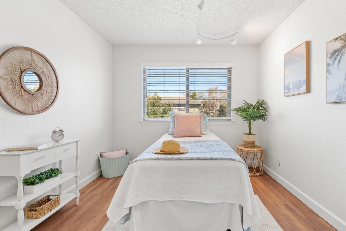 4465 Diamond Street, Unit 4 Capitola, CA 95010 - Photo 29 of 41 a bedroom with a bed and a potted plant