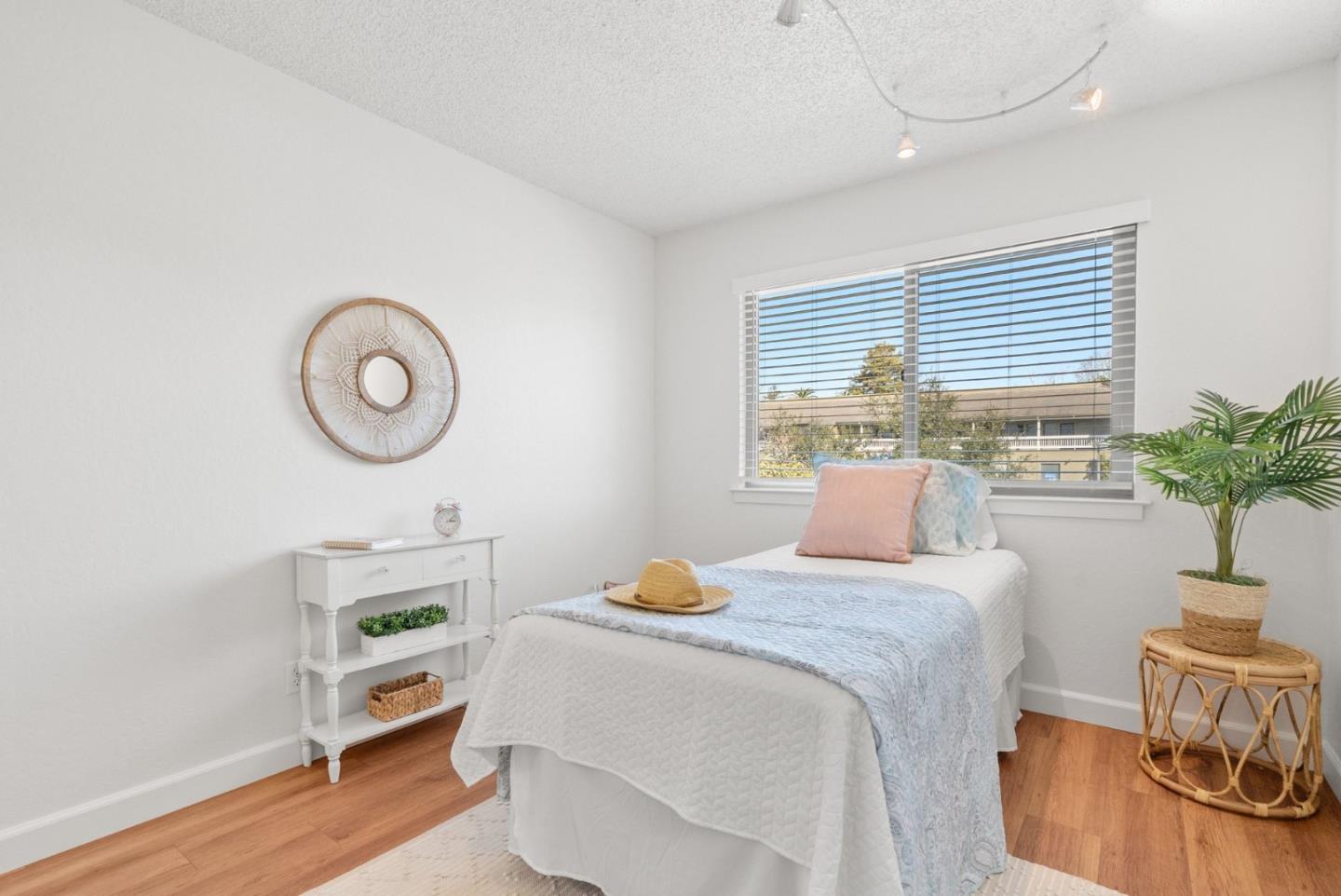 4465 Diamond Street, Unit 4 Capitola, CA 95010 - Photo 30 of 41 a bedroom with a bed a dresser and chair