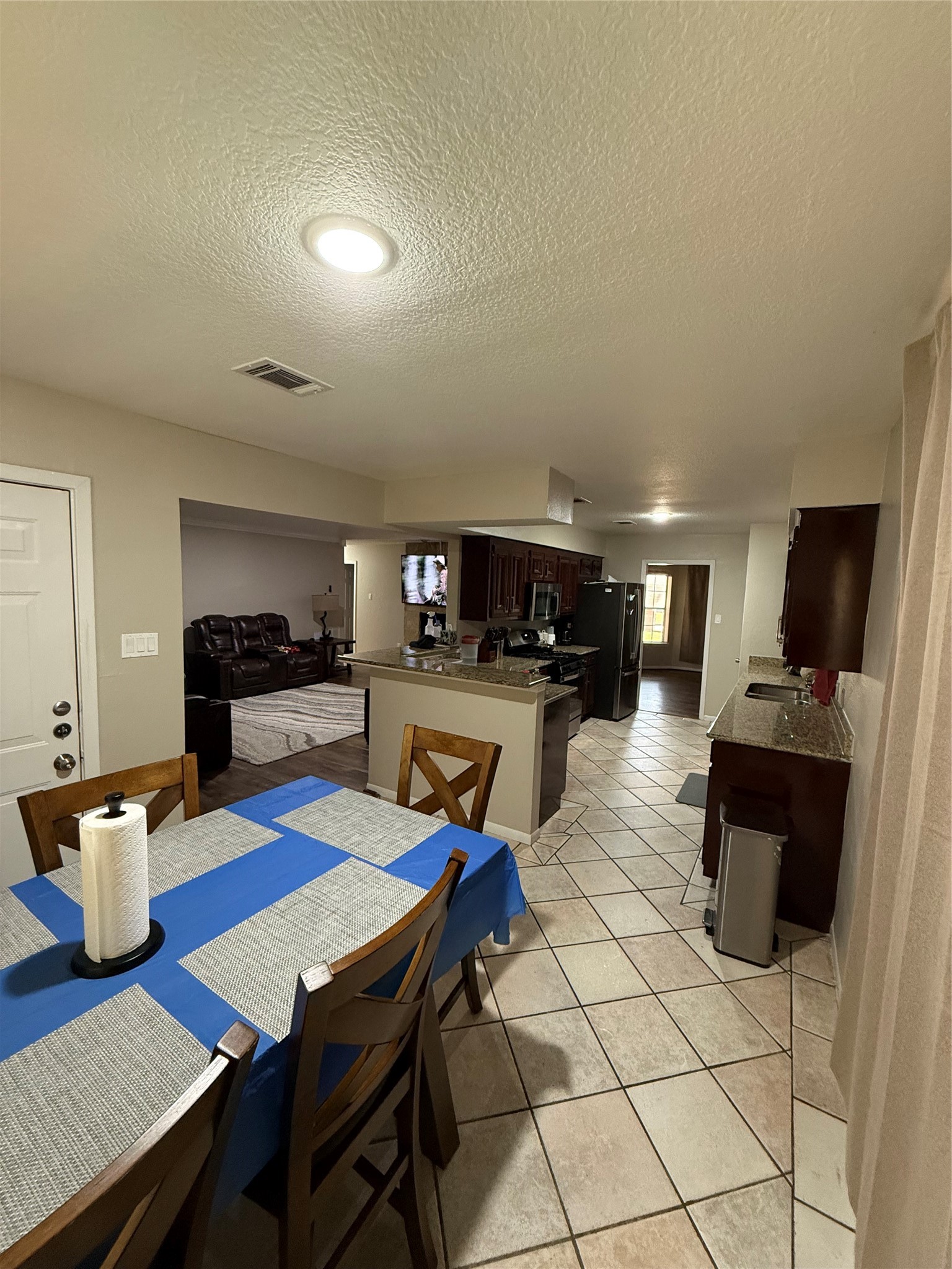 3103 Pine Dust Lane Spring, TX 77373 - Photo 23 of 29 a living room with furniture a flat screen tv and kitchen view