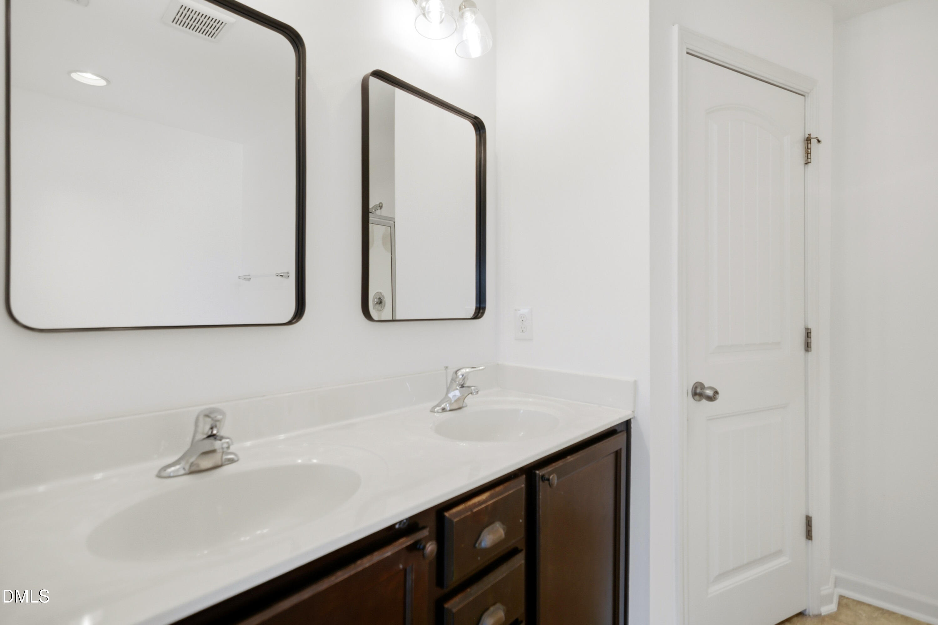 2700 Benevolence Drive Raleigh, NC 27610 - Photo 11 of 18 a bathroom with a sink and a mirror