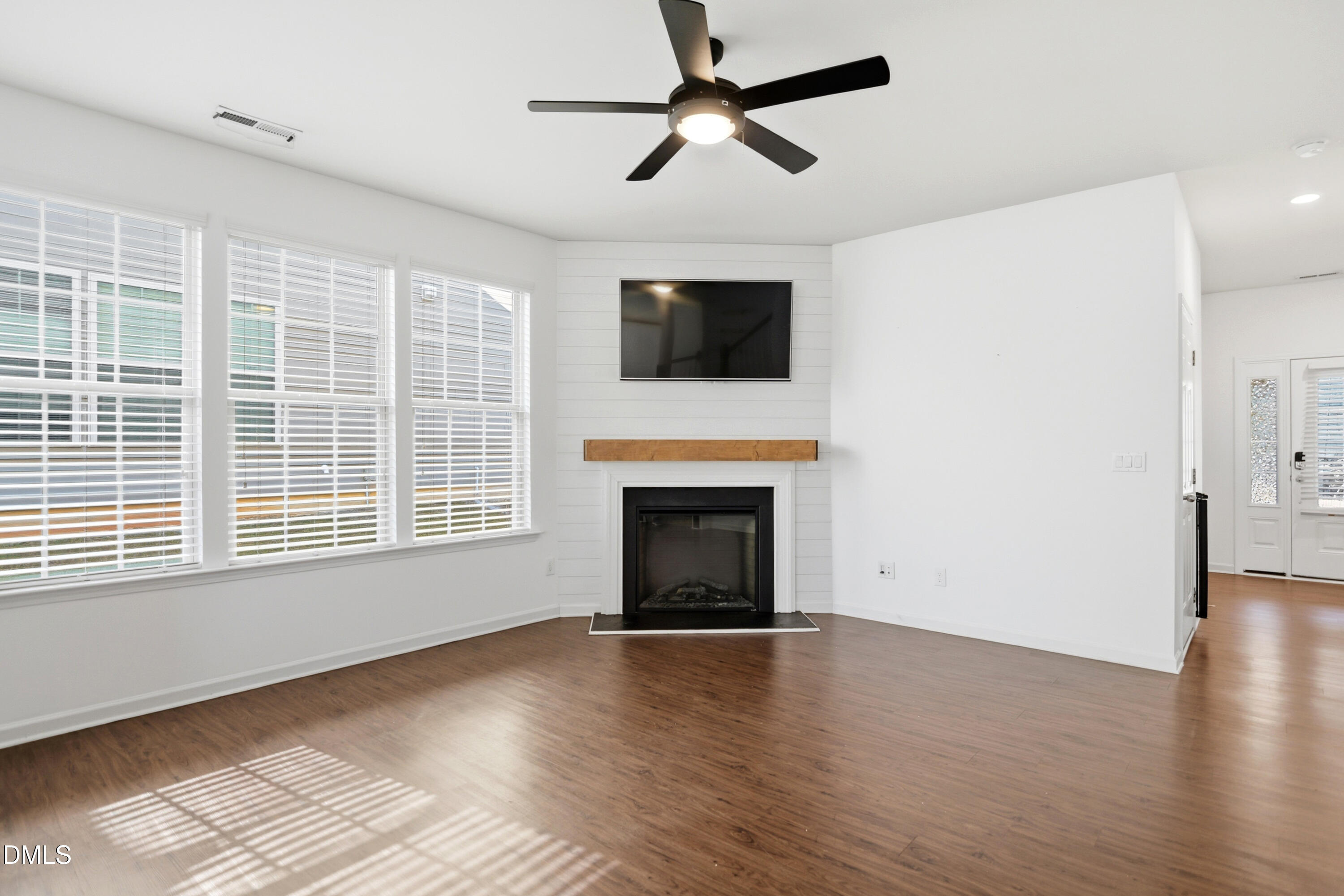 2700 Benevolence Drive Raleigh, NC 27610 - Photo 2 of 18 a view of an empty room with wooden floor fireplace and a window