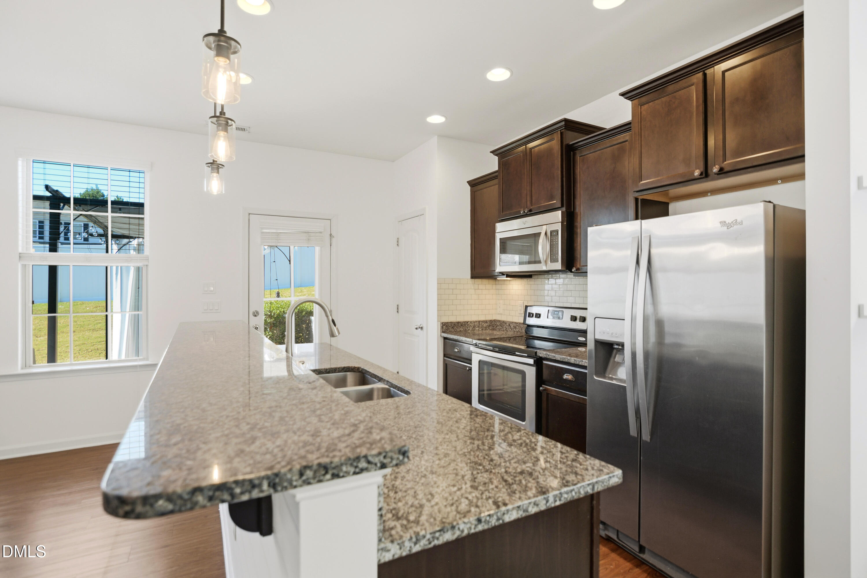 2700 Benevolence Drive Raleigh, NC 27610 - Photo 6 of 18 a kitchen with stainless steel appliances granite countertop a sink refrigerator and microwave