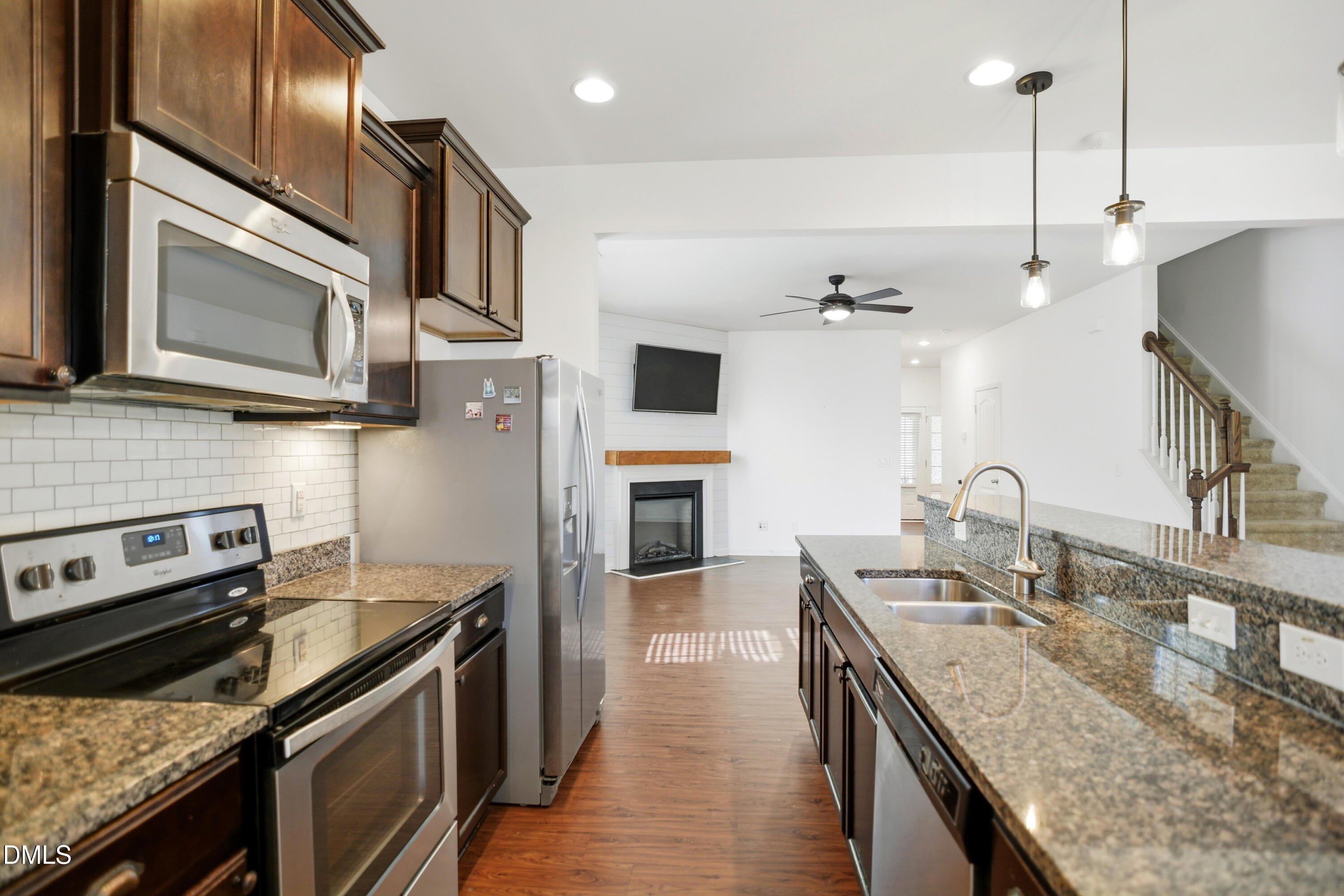 2700 Benevolence Drive Raleigh, NC 27610 - Photo 7 of 18 a kitchen with stainless steel appliances granite countertop a stove a sink and a microwave
