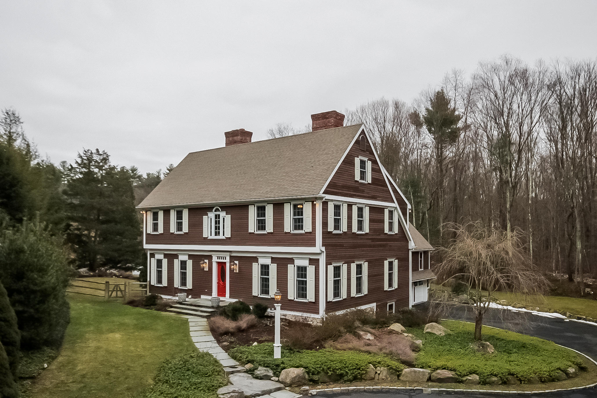 95 Cascade Road Stamford, CT 06903 - Photo 1 of 26 a aerial view of a house next to a big yard and large trees
