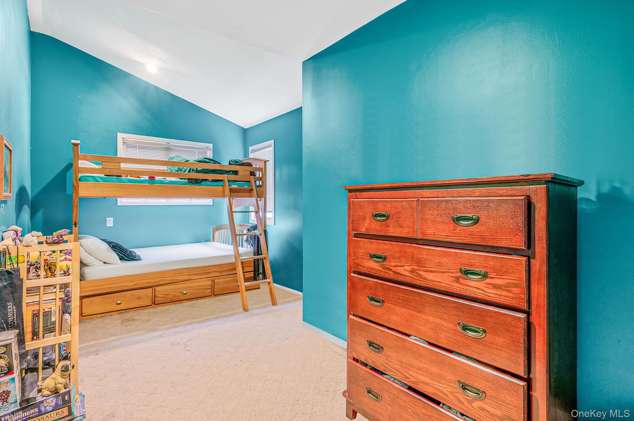 194 Central Park Road Plainview, NY 11803 - Photo 13 of 19 Bedroom with light colored carpet and vaulted ceiling