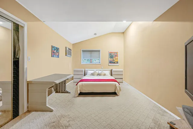 a bedroom with a bed and a white wall painting