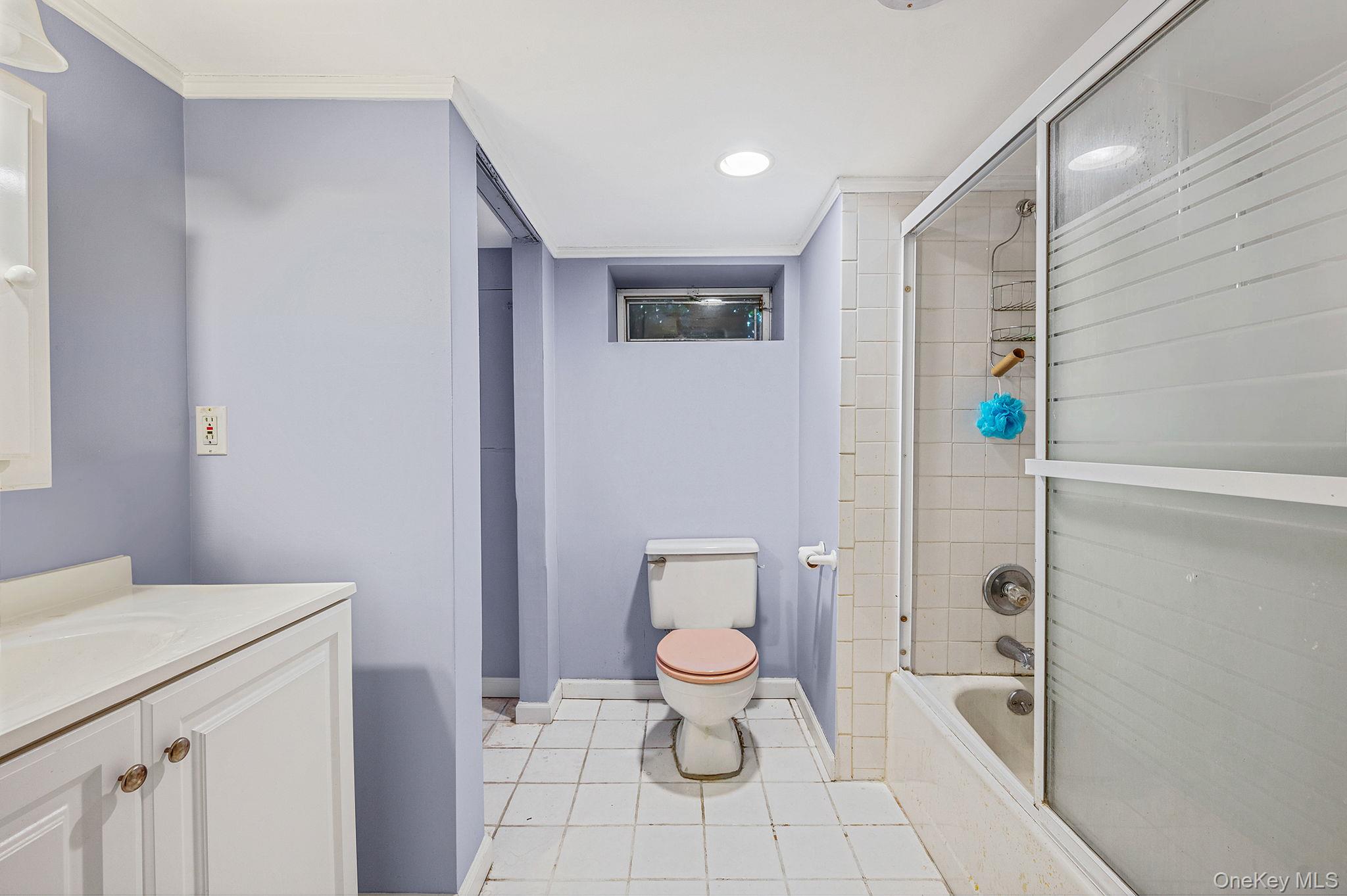 194 Central Park Road Plainview, NY 11803 - Photo 19 of 19 Full bathroom with enclosed tub / shower combo, vanity, crown molding, light tile patterned floors, and recessed lighting