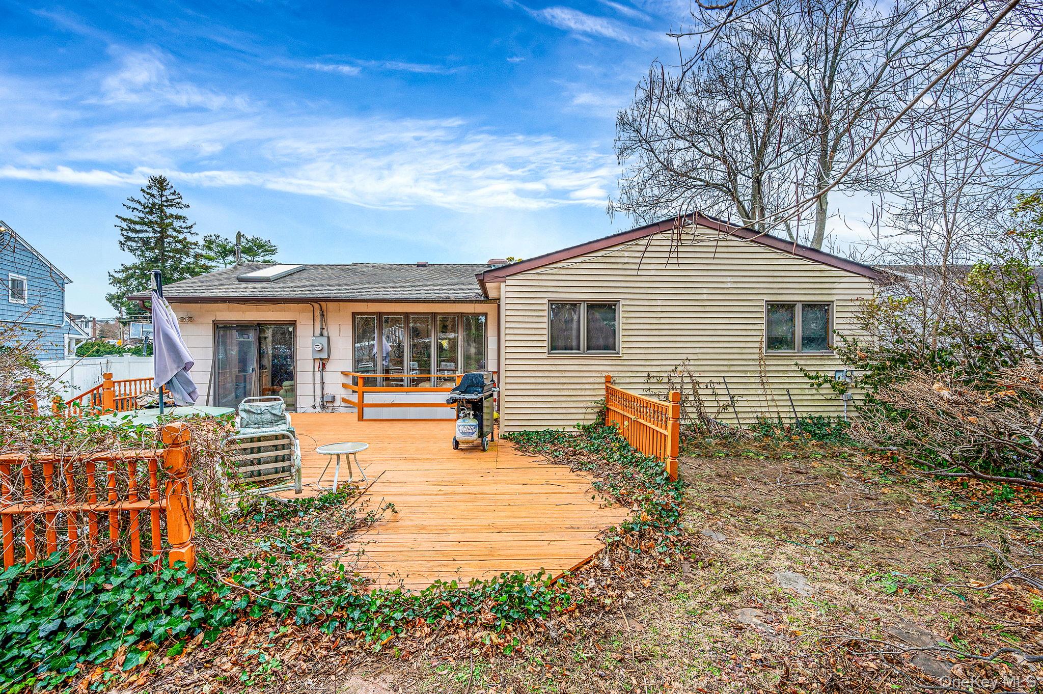 194 Central Park Road Plainview, NY 11803 - Photo 3 of 19 Back of property with a deck and a shingled roof