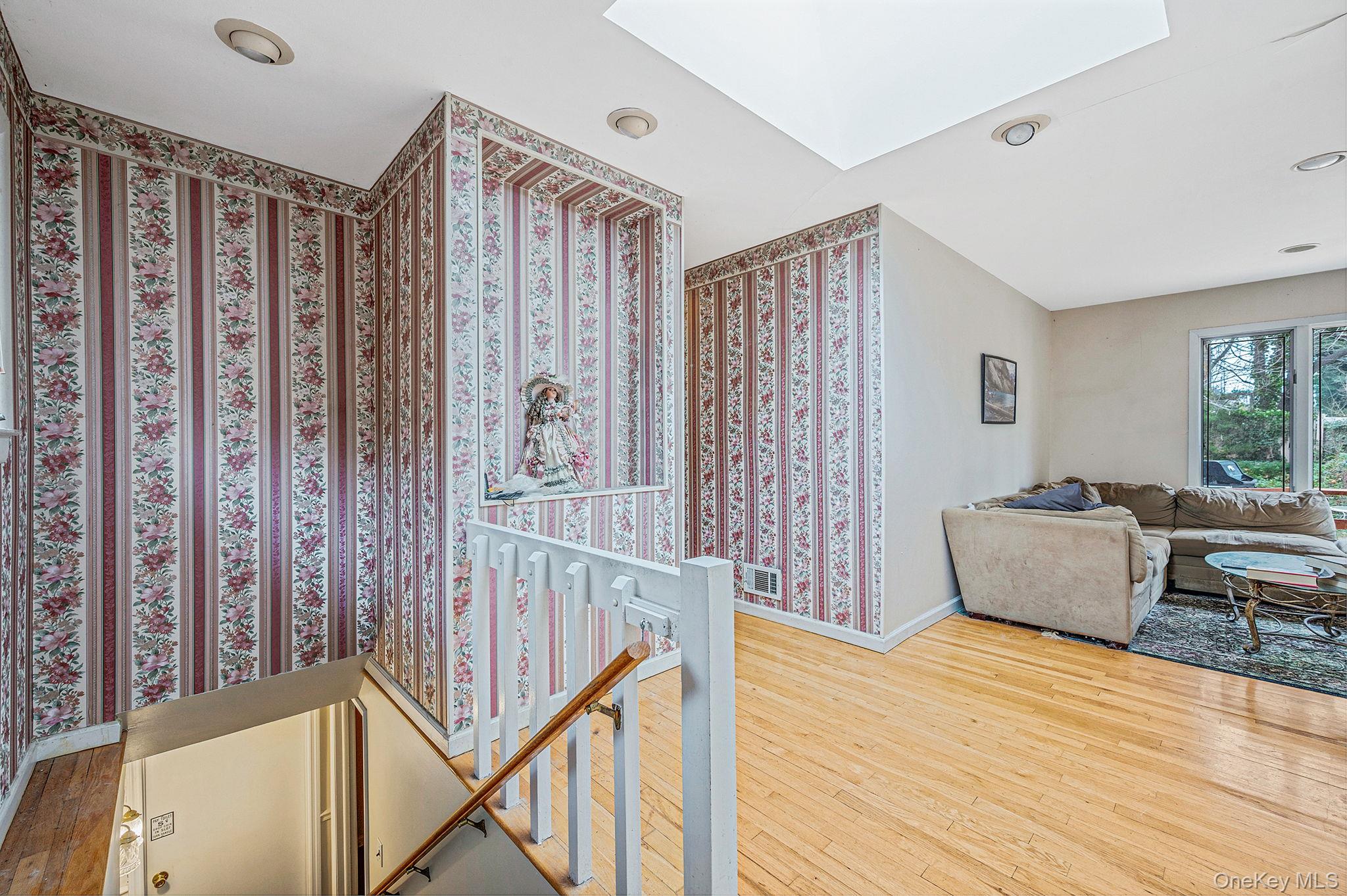 194 Central Park Road Plainview, NY 11803 - Photo 6 of 19 Corridor featuring an upstairs landing, hardwood / wood-style flooring, a skylight, and recessed lighting