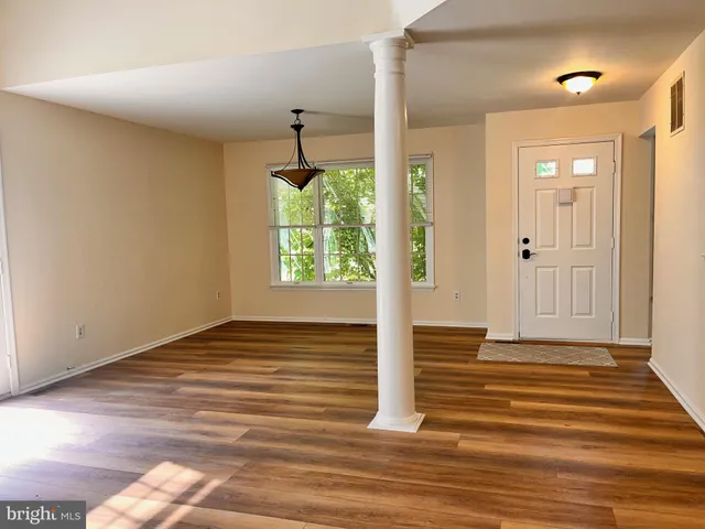 a view of a livingroom with wooden floor and a window